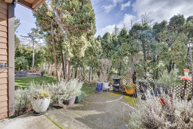 view of yard with a patio area, a fire pit, and fence