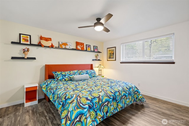 bedroom featuring a ceiling fan, baseboards, and wood finished floors