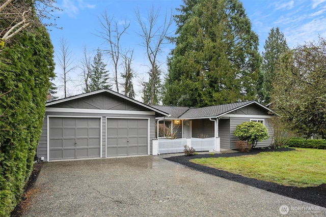 single story home featuring a front lawn, driveway, a porch, metal roof, and a garage