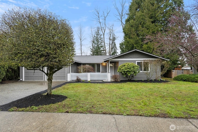 ranch-style house with a front yard, an attached garage, and driveway