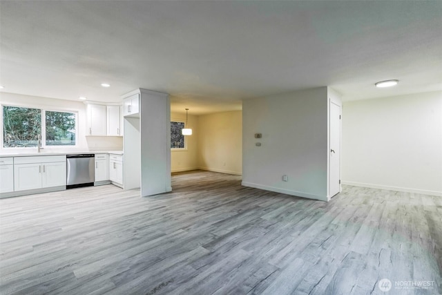 unfurnished living room featuring recessed lighting, baseboards, and light wood-style flooring