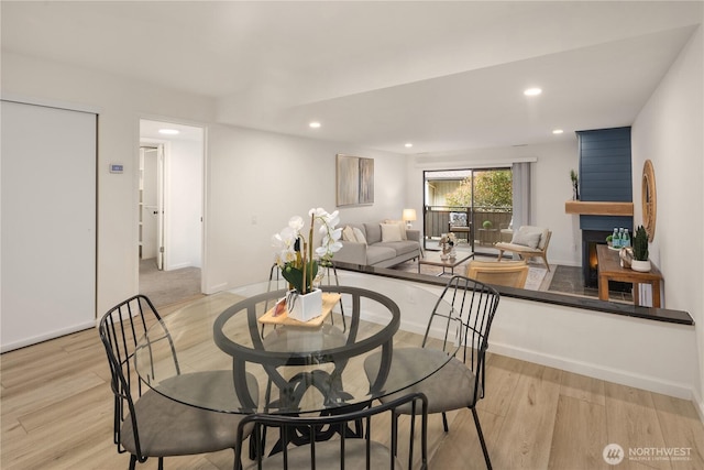 dining room featuring recessed lighting, baseboards, and wood finished floors