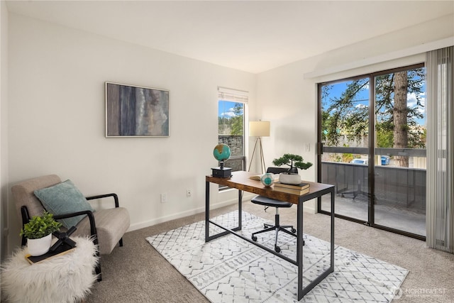 office space featuring light colored carpet and baseboards