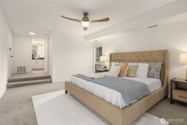 bedroom featuring a ceiling fan, carpet, visible vents, and ensuite bathroom