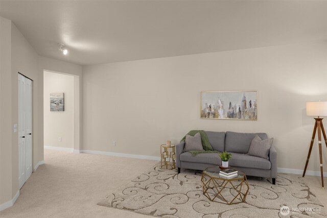 carpeted living room with baseboards