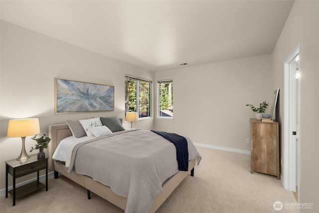 bedroom with visible vents, baseboards, and light colored carpet