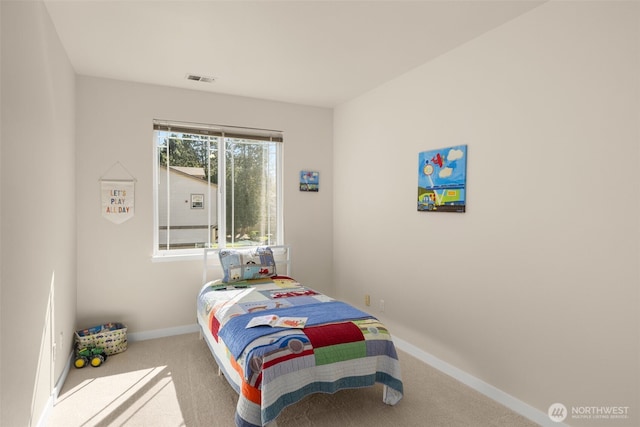 carpeted bedroom with visible vents and baseboards