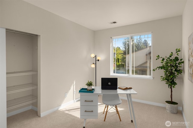 office area with visible vents, baseboards, and carpet