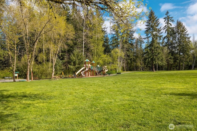 view of yard featuring a playground and a view of trees