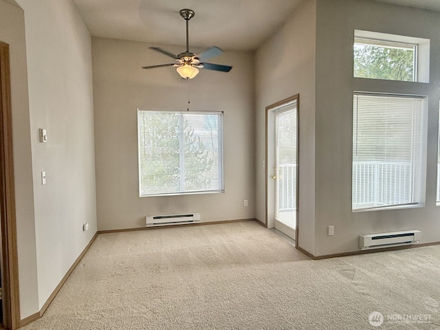 unfurnished room featuring carpet, baseboards, and baseboard heating