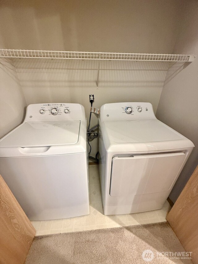 washroom featuring carpet floors, laundry area, and washer and clothes dryer