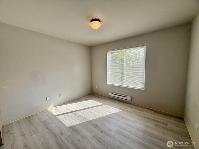 22212 42nd Ave S Unit 204, Kent, WA 98032 - empty room with baseboard heating and wood finished floors