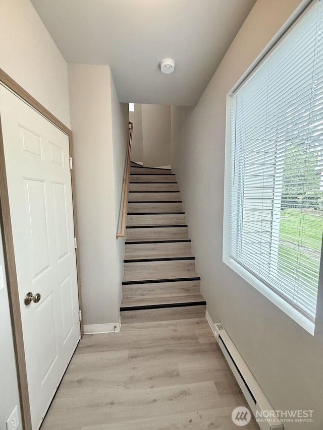 22212 42nd Ave S Unit 204, Kent, WA 98032 - staircase with a baseboard heating unit and wood finished floors