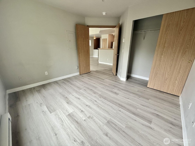 22212 42nd Ave S Unit 204, Kent, WA 98032 - unfurnished bedroom with light wood finished floors, a closet, and electric panel