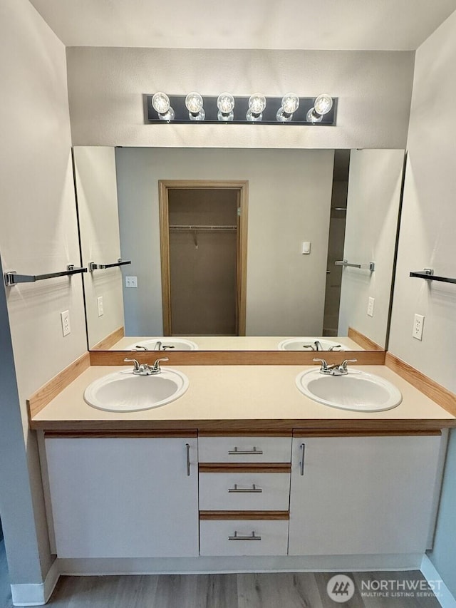 22212 42nd Ave S Unit 204, Kent, WA 98032 - bathroom featuring double vanity, wood finished floors, and a spacious closet