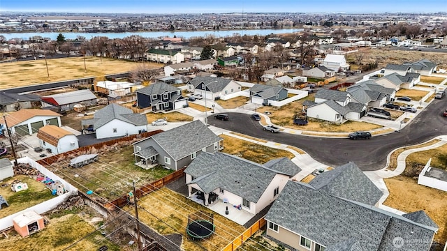 birds eye view of property with a residential view and a water view