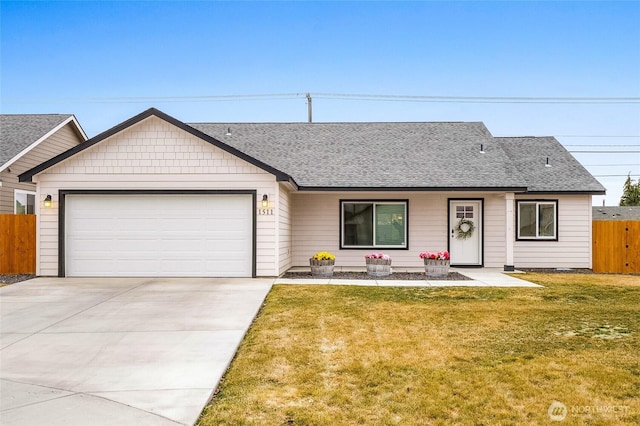 view of front facade with an attached garage, a front lawn, roof with shingles, and fence