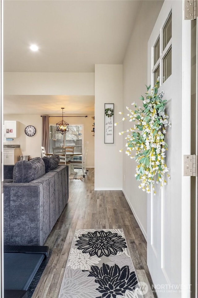 hallway featuring baseboards and wood finished floors