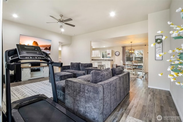 living room with recessed lighting, ceiling fan, baseboards, and wood finished floors