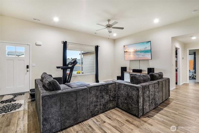 living area with recessed lighting, light wood-style flooring, and a ceiling fan