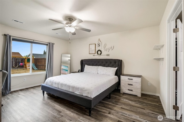 bedroom featuring ceiling fan, visible vents, baseboards, and wood finished floors