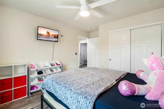 bedroom featuring ceiling fan, a closet, and wood finished floors