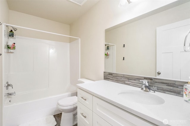 bathroom featuring shower / washtub combination, toilet, and vanity