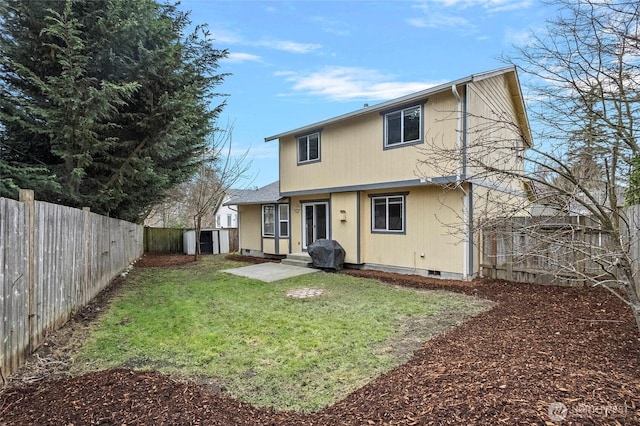 rear view of property featuring crawl space, a yard, a fenced backyard, and entry steps