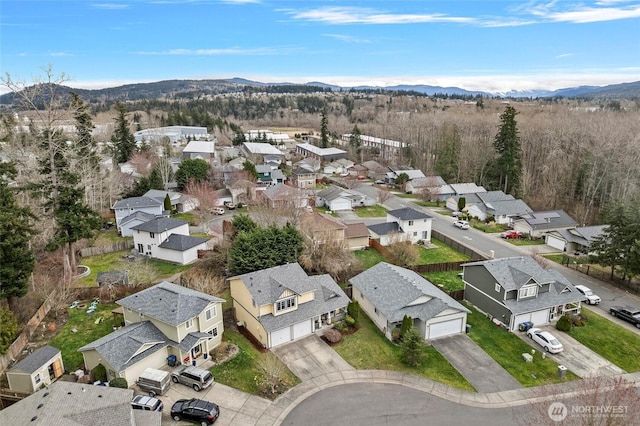 birds eye view of property with a mountain view and a residential view