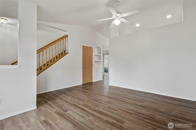 unfurnished living room featuring wood finished floors, baseboards, a ceiling fan, stairs, and vaulted ceiling