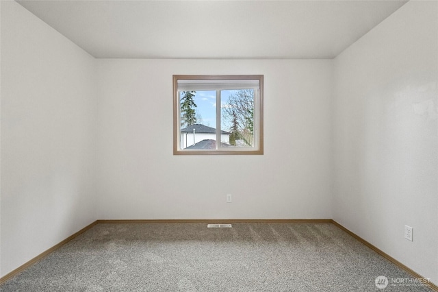 unfurnished room featuring visible vents, baseboards, and carpet floors