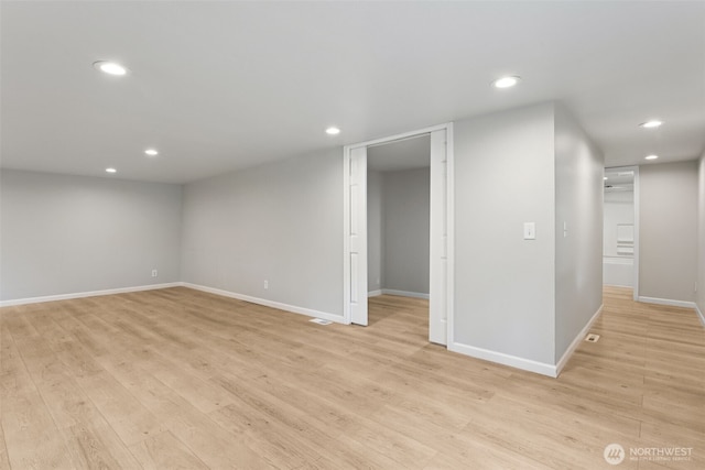 unfurnished room with recessed lighting, light wood-type flooring, and baseboards