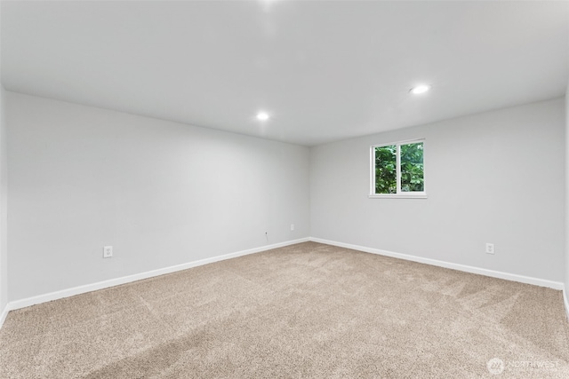 carpeted spare room featuring recessed lighting and baseboards