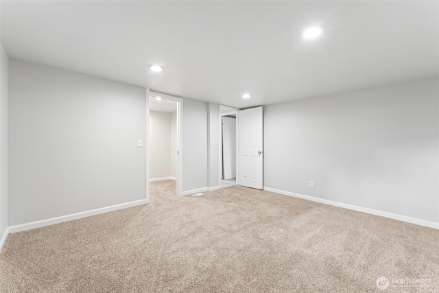 interior space featuring recessed lighting, light colored carpet, and baseboards