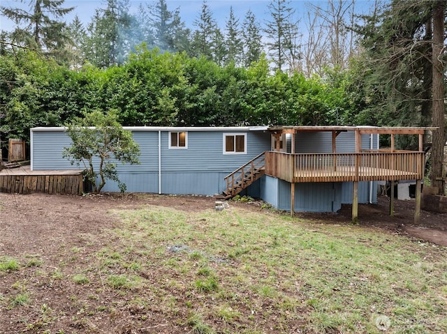 rear view of house with a deck and stairs