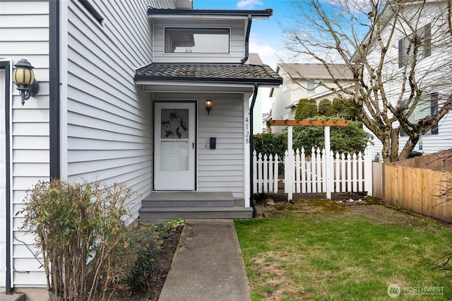 view of exterior entry featuring fence