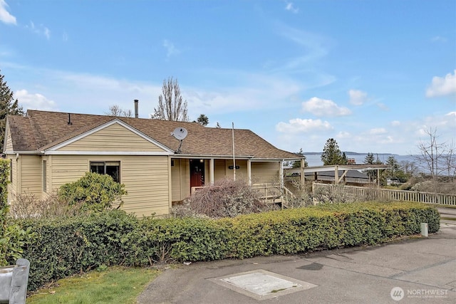 view of front of home featuring roof with shingles