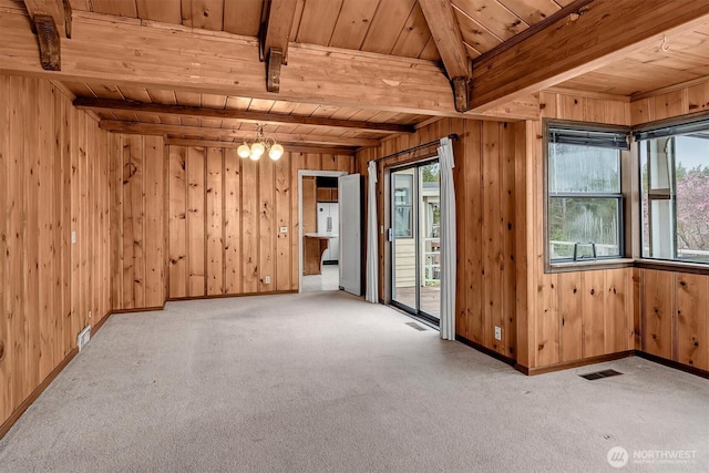 spare room featuring wooden ceiling, beamed ceiling, and carpet floors