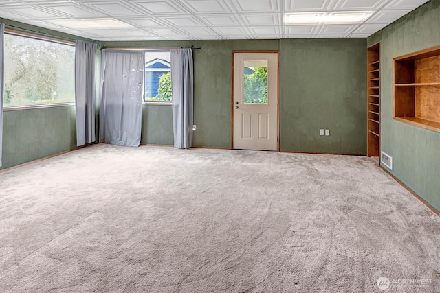 spare room featuring visible vents, an ornate ceiling, and carpet floors