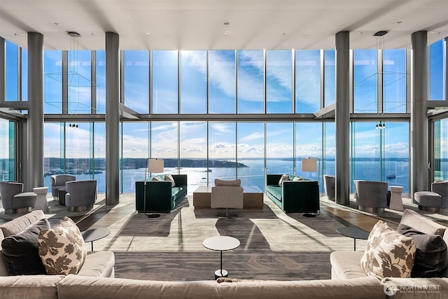 living room with a water view and floor to ceiling windows