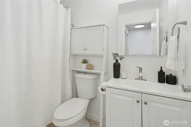 bathroom featuring toilet and vanity