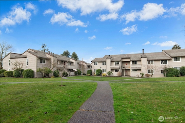 view of property's community featuring a yard and a residential view