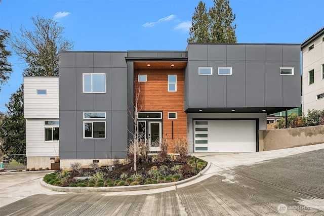 modern home featuring concrete driveway, an attached garage, and crawl space