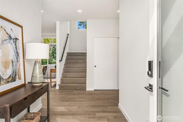 interior space with stairway, recessed lighting, and wood finished floors