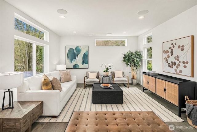 living room featuring visible vents, recessed lighting, baseboards, and wood finished floors