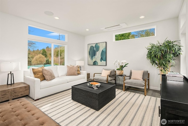 living room with recessed lighting, wood finished floors, visible vents, and baseboards