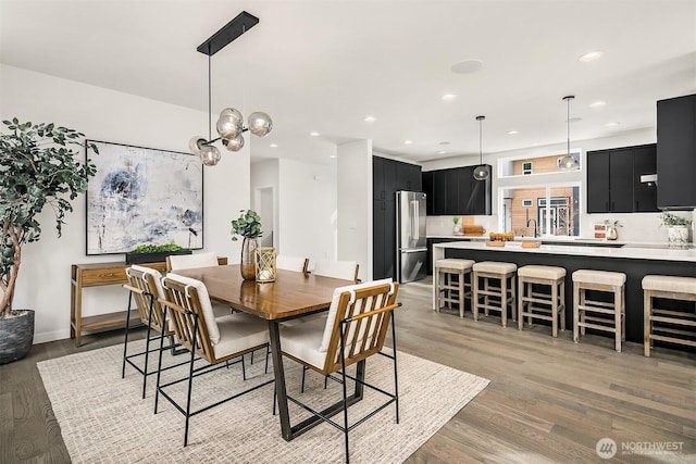 dining space with recessed lighting and light wood finished floors