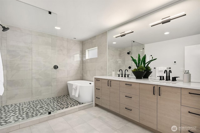 bathroom with a sink, double vanity, tile walls, and tiled shower