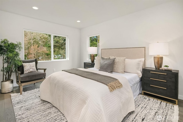 bedroom with recessed lighting and wood finished floors