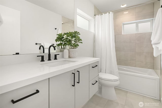 bathroom with tile patterned floors, toilet, vanity, and shower / bath combination with curtain